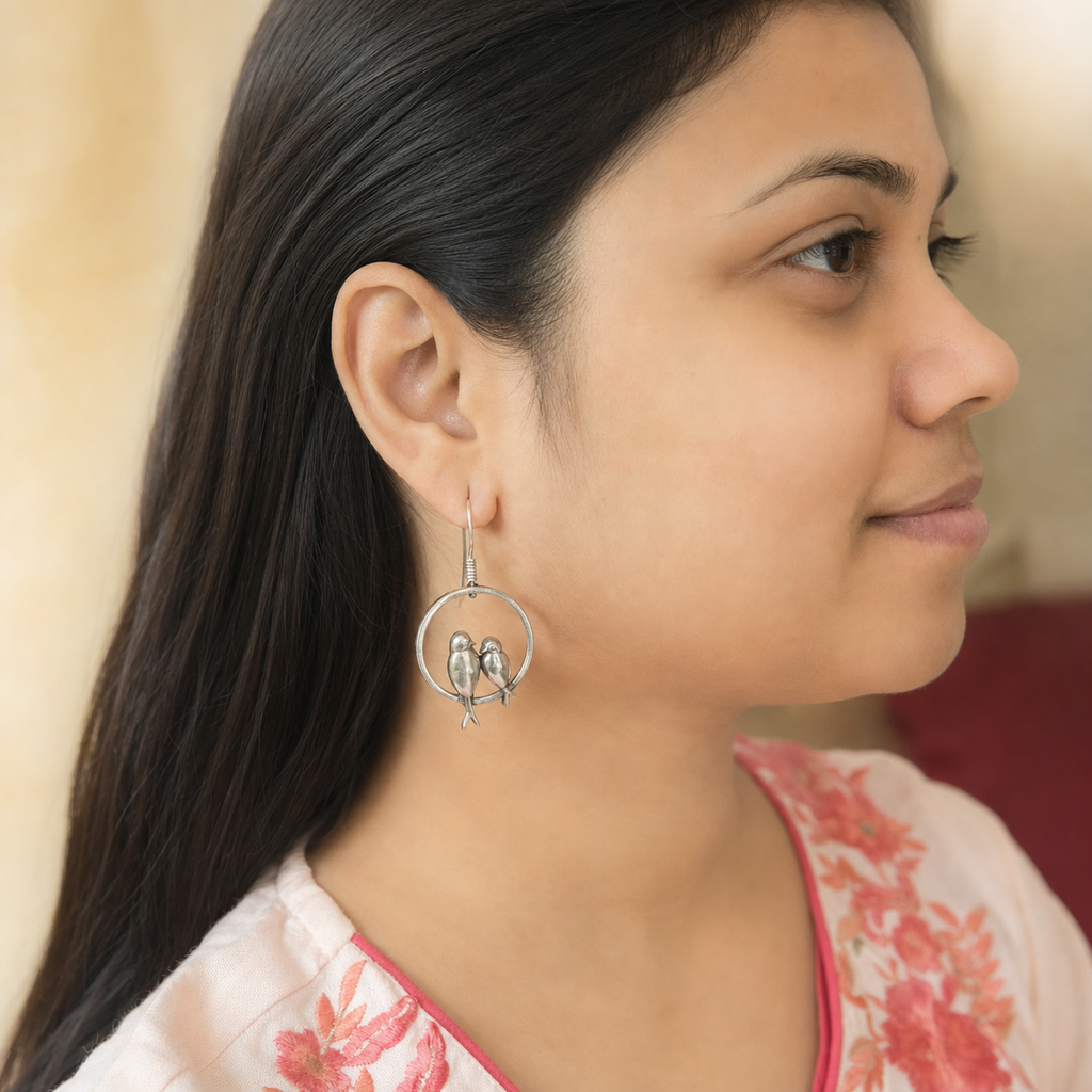 Do Panchi silver fishhook earring with two birds worn on the ear