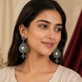 Oxidized silver teardrop dangler earrings worn on ears