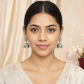 Classic oxidized silver jhumka earrings worn on both ears