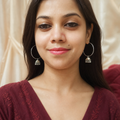 Elegant oxidized silver jhumki hoop earrings worn on both ears