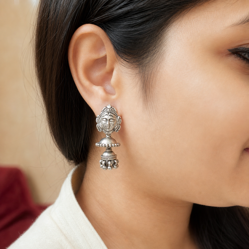 Aadi Sakti layered silver jhumki worn on the ear